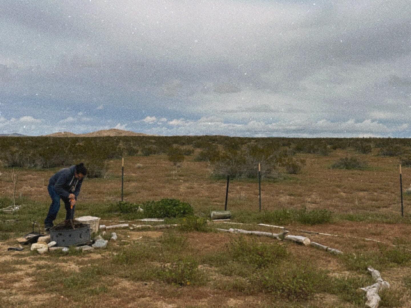 Volunteer Chopping Wood at the Tiny Forest in the Desert