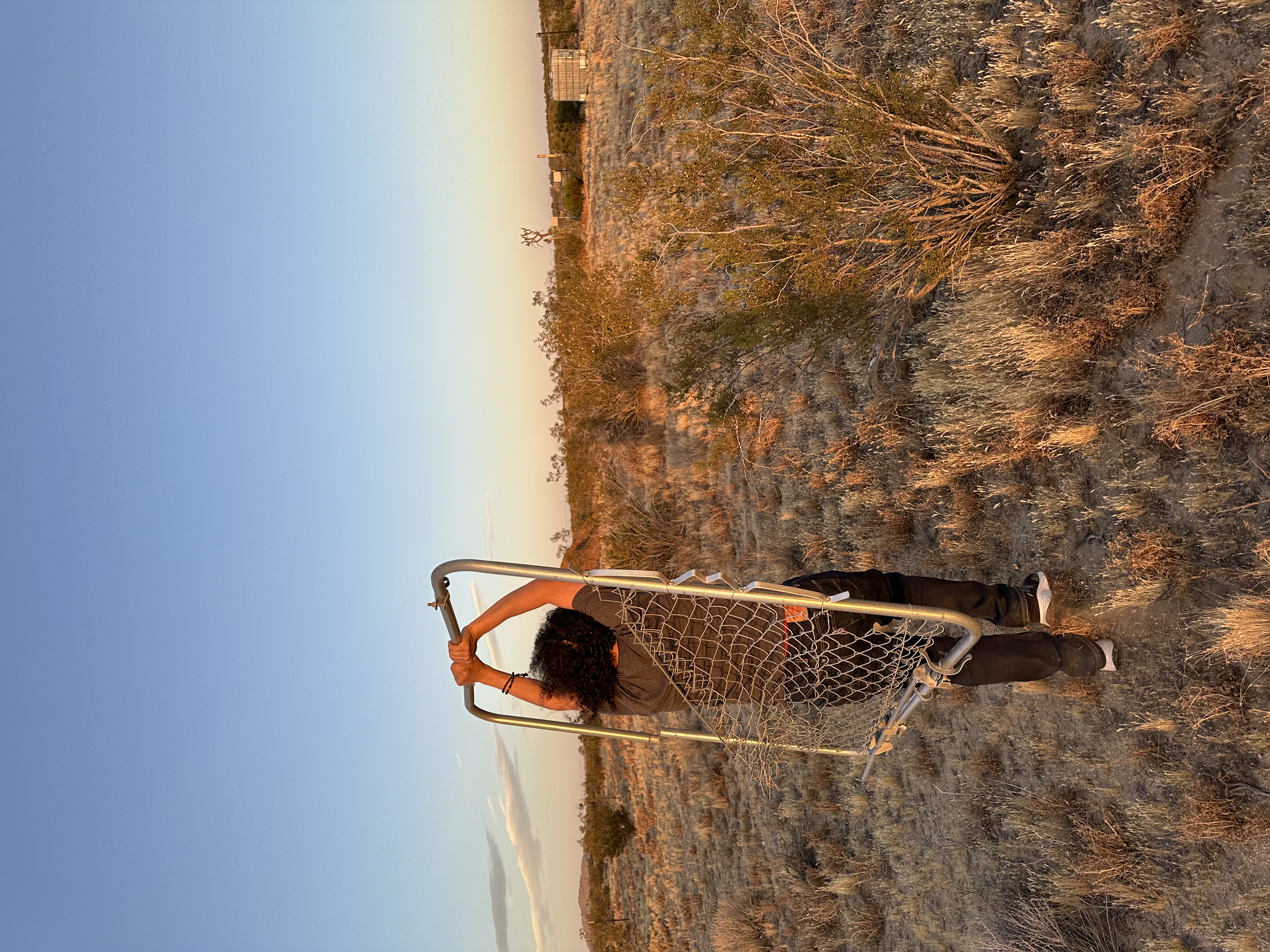 Volunteer Earthworker fixing a fence at For Every Star, A Tree