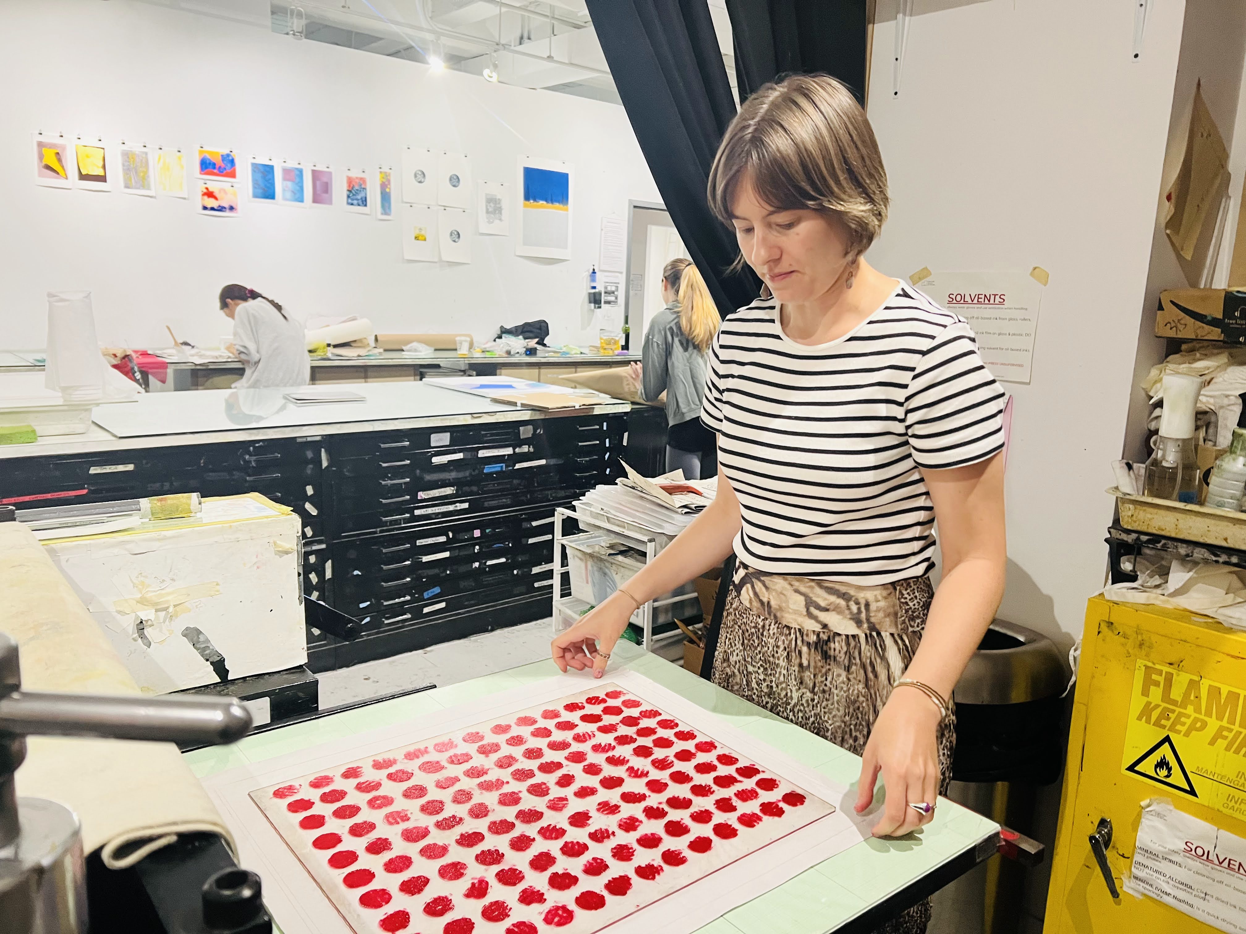 me at the printing press with a plate full of inked red circles