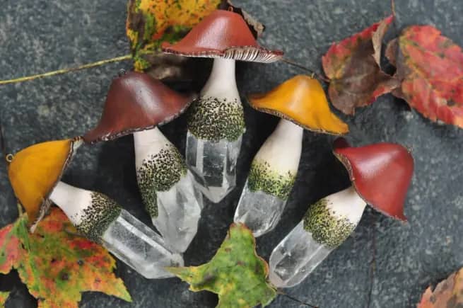 Ceramic mushrooms with quartz crystal stems on table