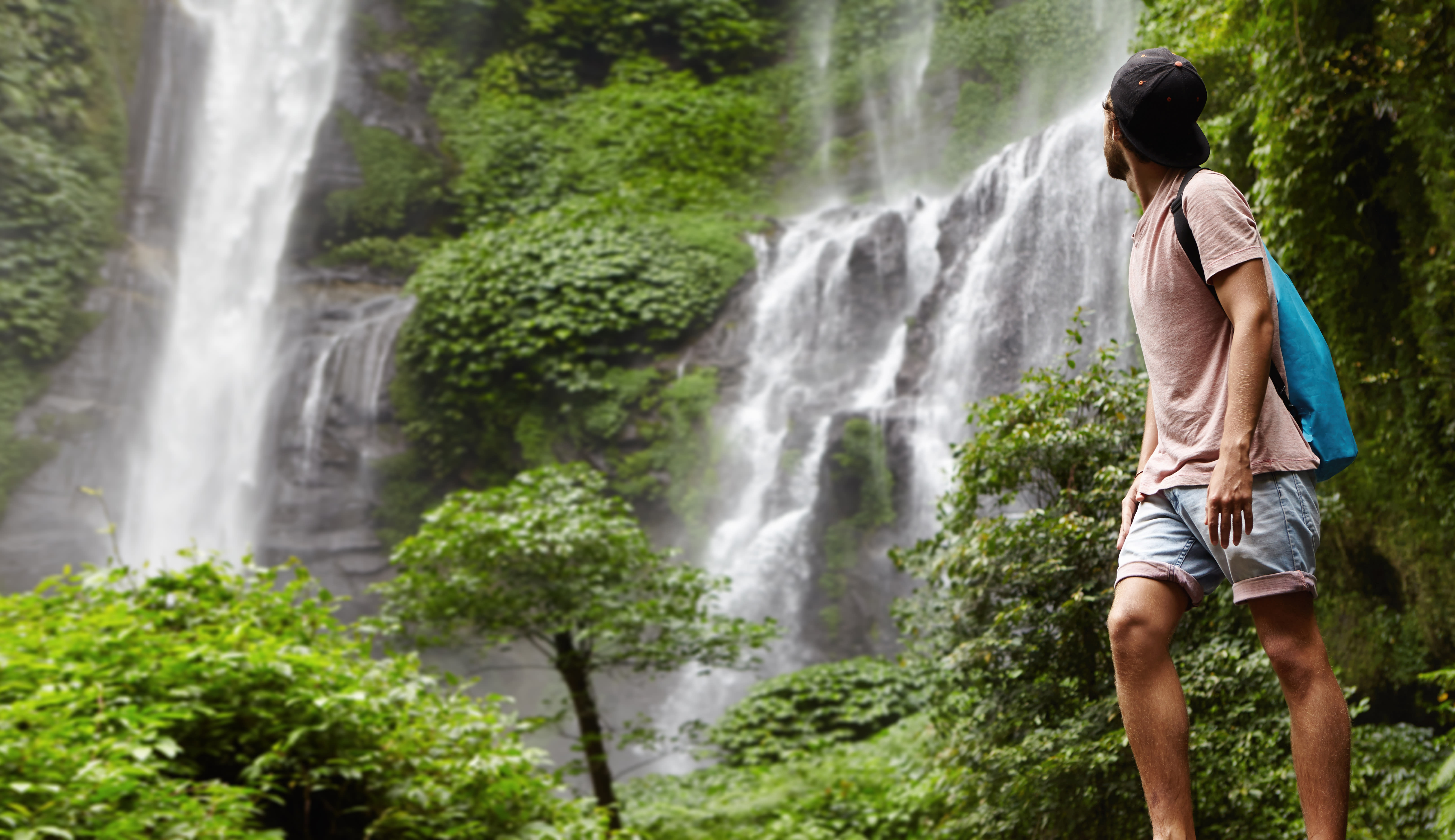 Hiker at waterfall - adventure trekking experience in Sri Lanka highlands