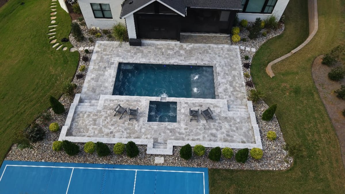Aerial drone photograph of a property with a pool in the Raleigh area