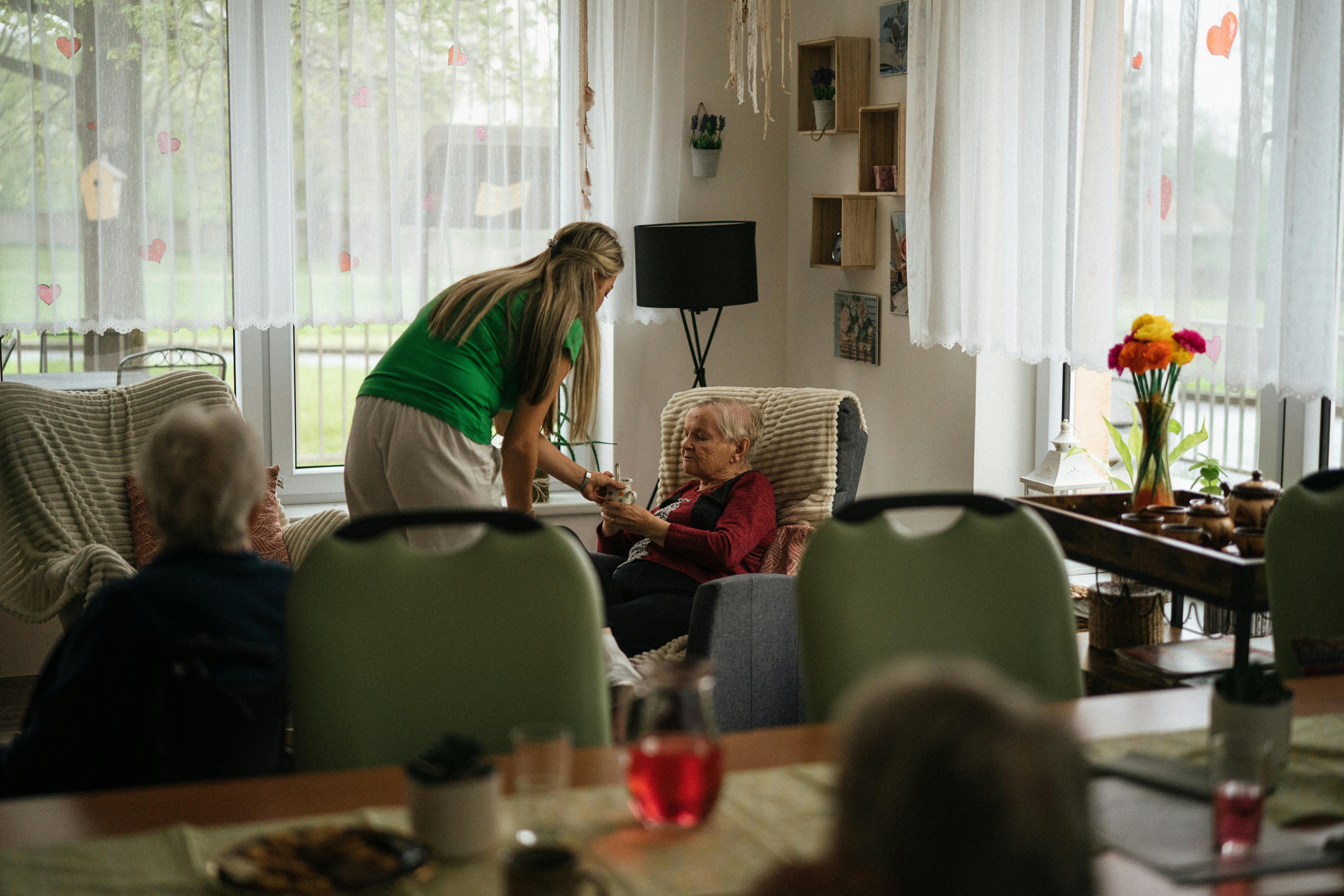 Caregiver holding hands with senior