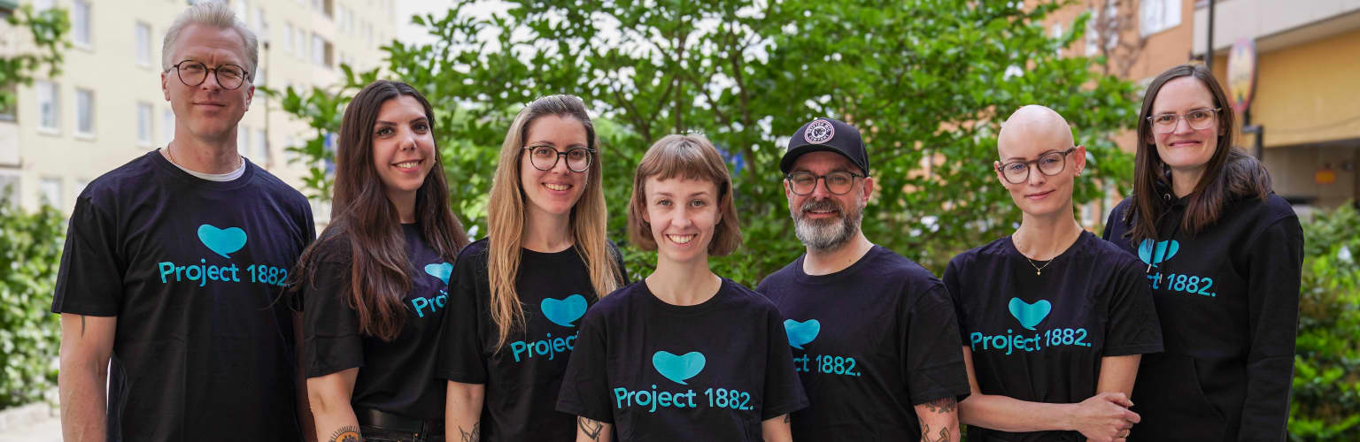 The leadership team in Project 1882 merch outside.