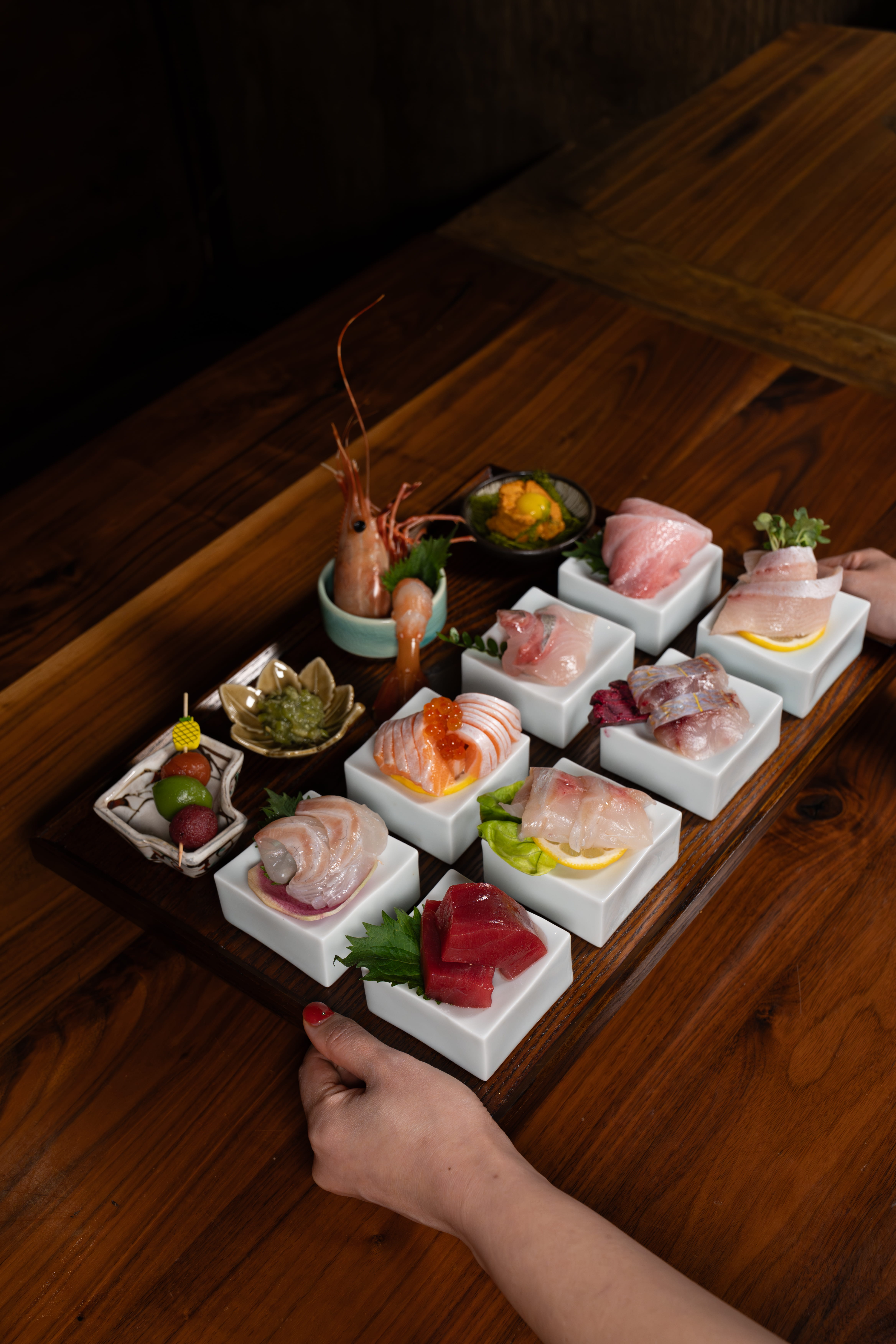 Beautifully plated sushi dishes arranged on ceramic plates at the Yume Long Beach location, showcasing fresh fish and artistic presentation