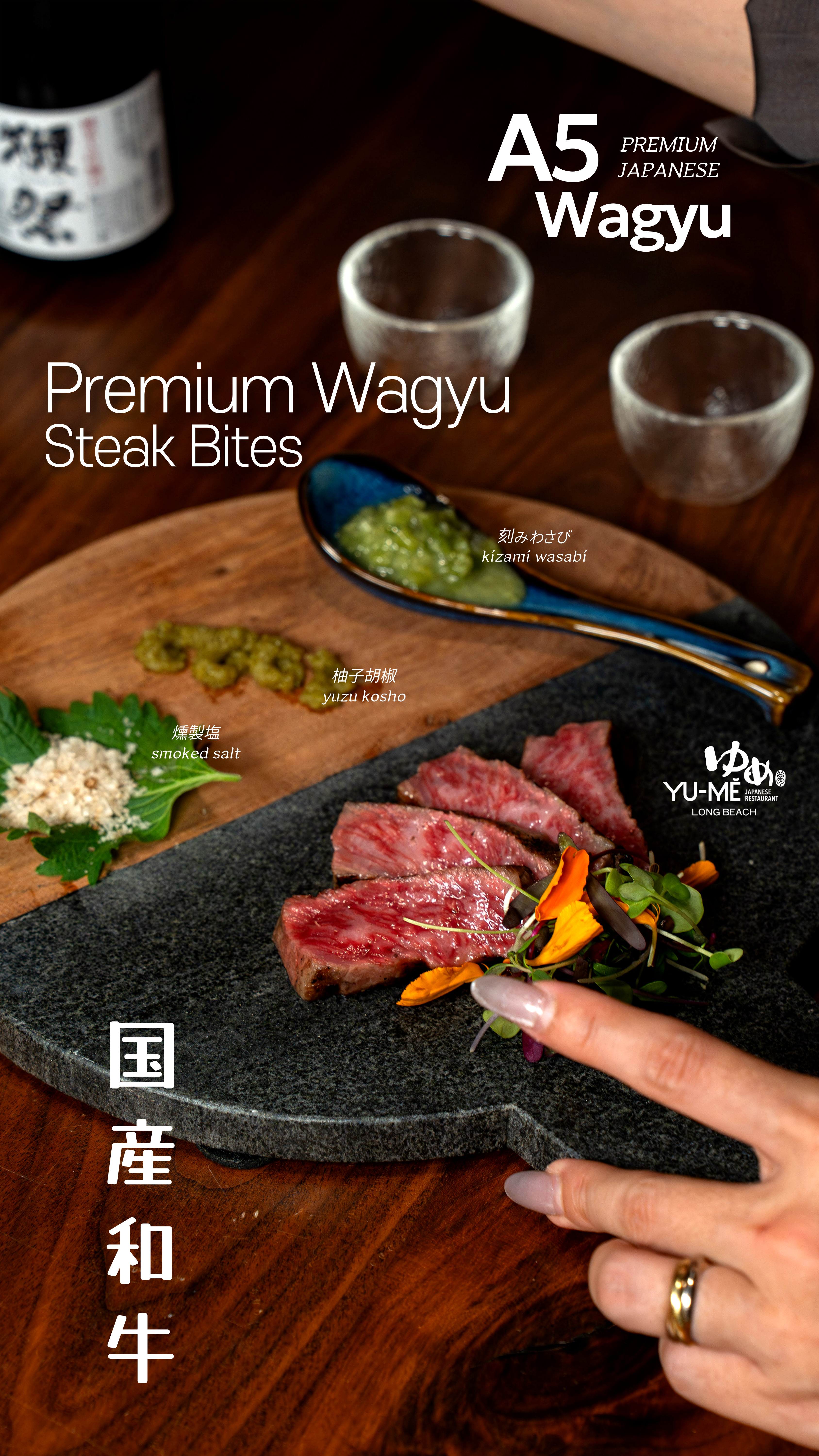Yume Long Beach premium A5 Wagyu steak bites served on a black stone plate with microgreens and accompanied by smoked salt, yuzu kosho, and kizami wasabi. (2 of 6)