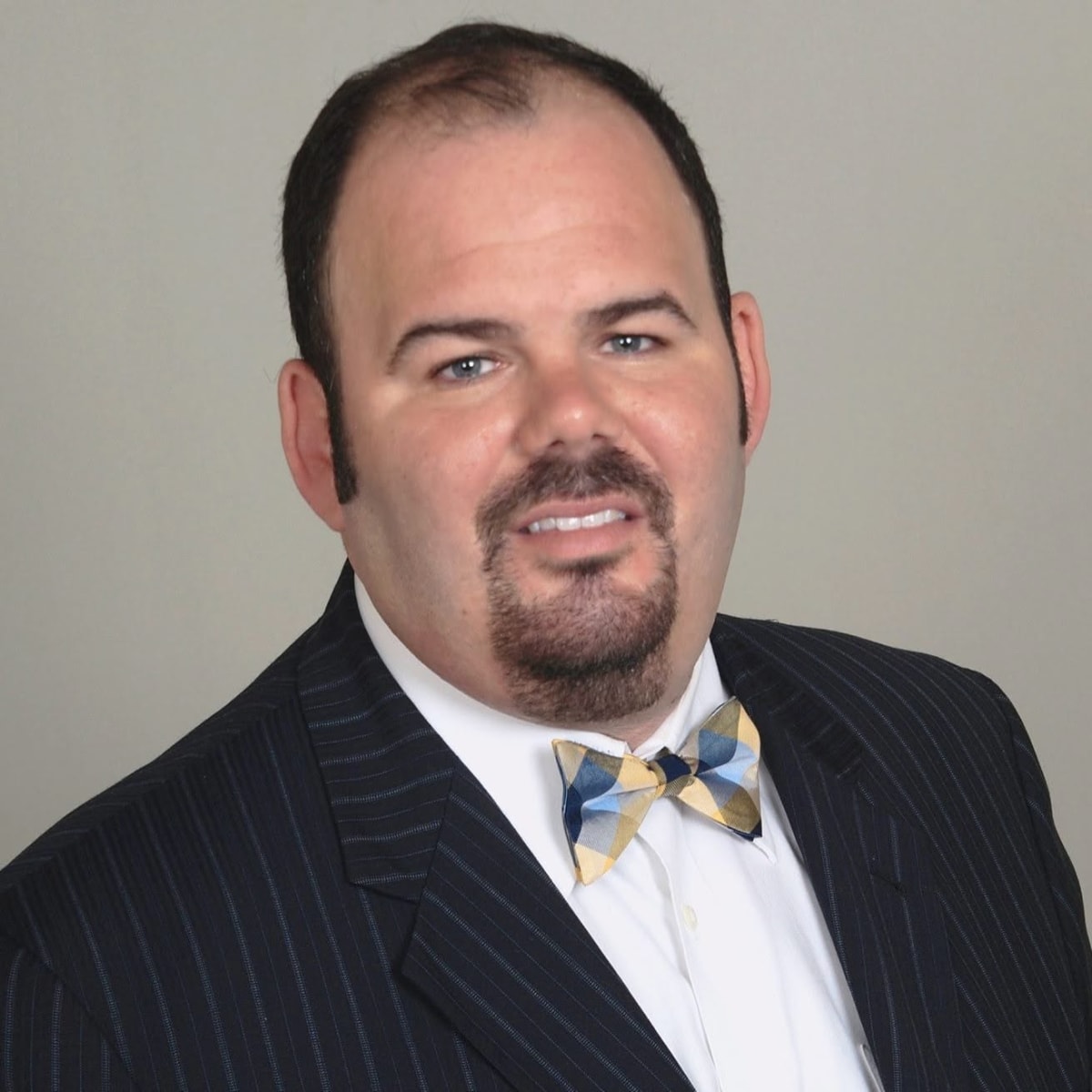 Headshot of Matthew Glassman, a Broward County criminal defense lawyer, wearing a pinstriped navy suit and white dress shirt.