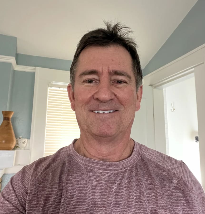 Thomas Vaughan, an Orlando workers' compensation attorney, smiling in a casual indoor photo.