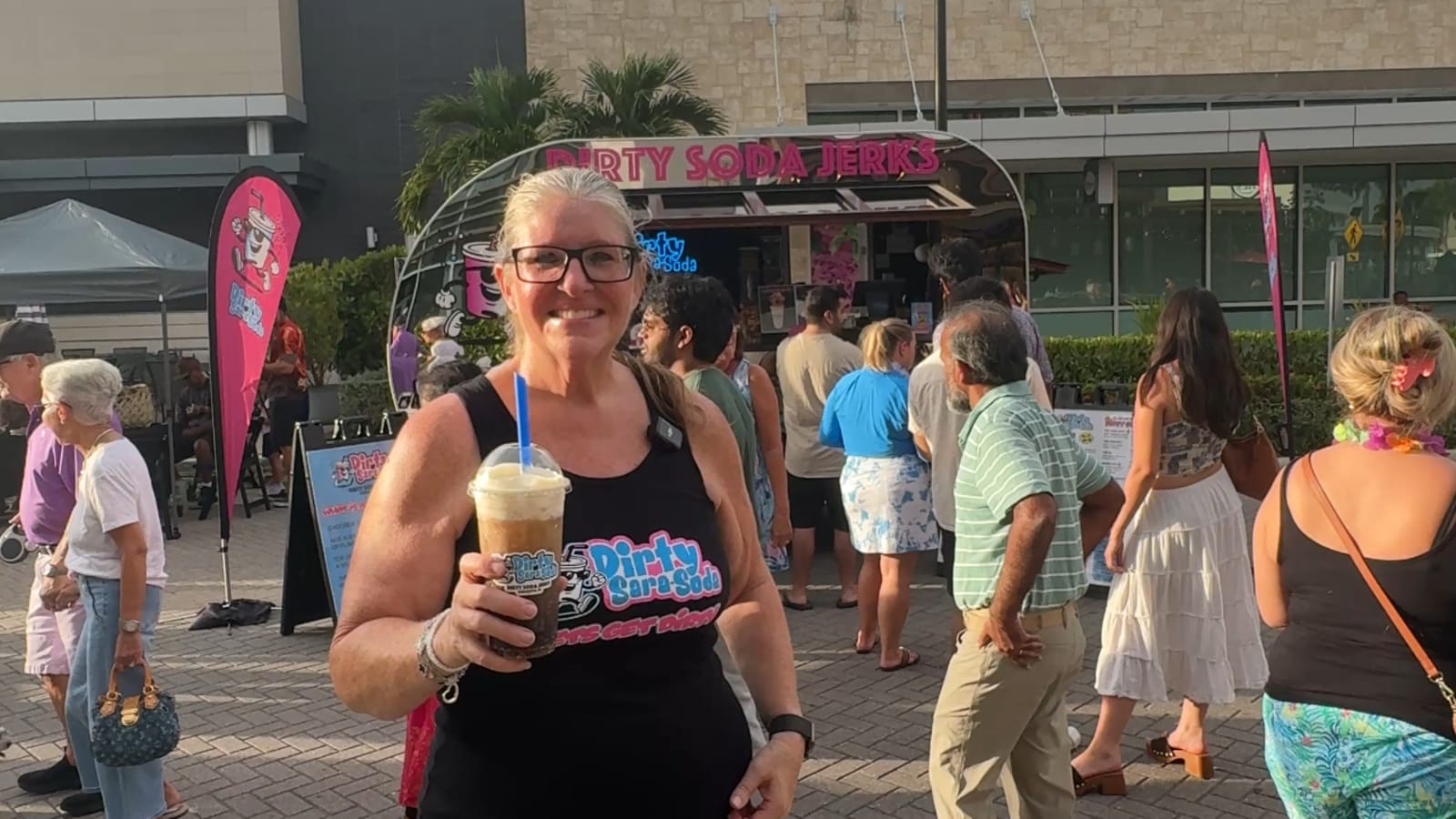 Amber Hanratty holding a dirty soda in front of the Dirty SaraSoda trailer at the UTC Night Market