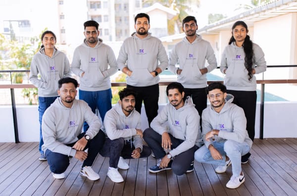 Exline Labs team posing in branded T-shirts