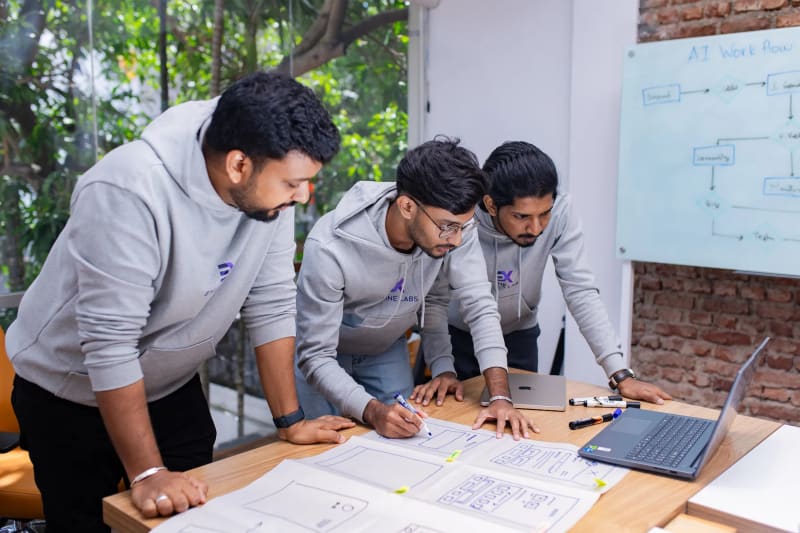 Startup-focused web design agency team collaborating on laptops