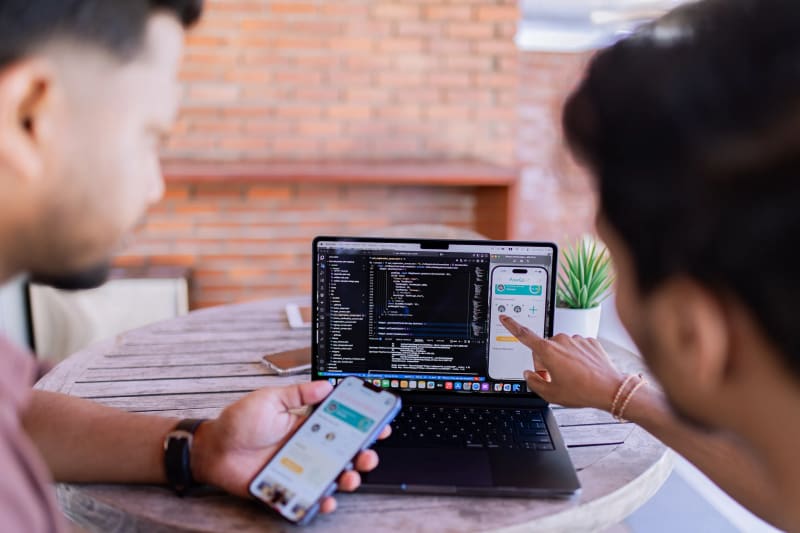 Custom mobile app development company team working in office