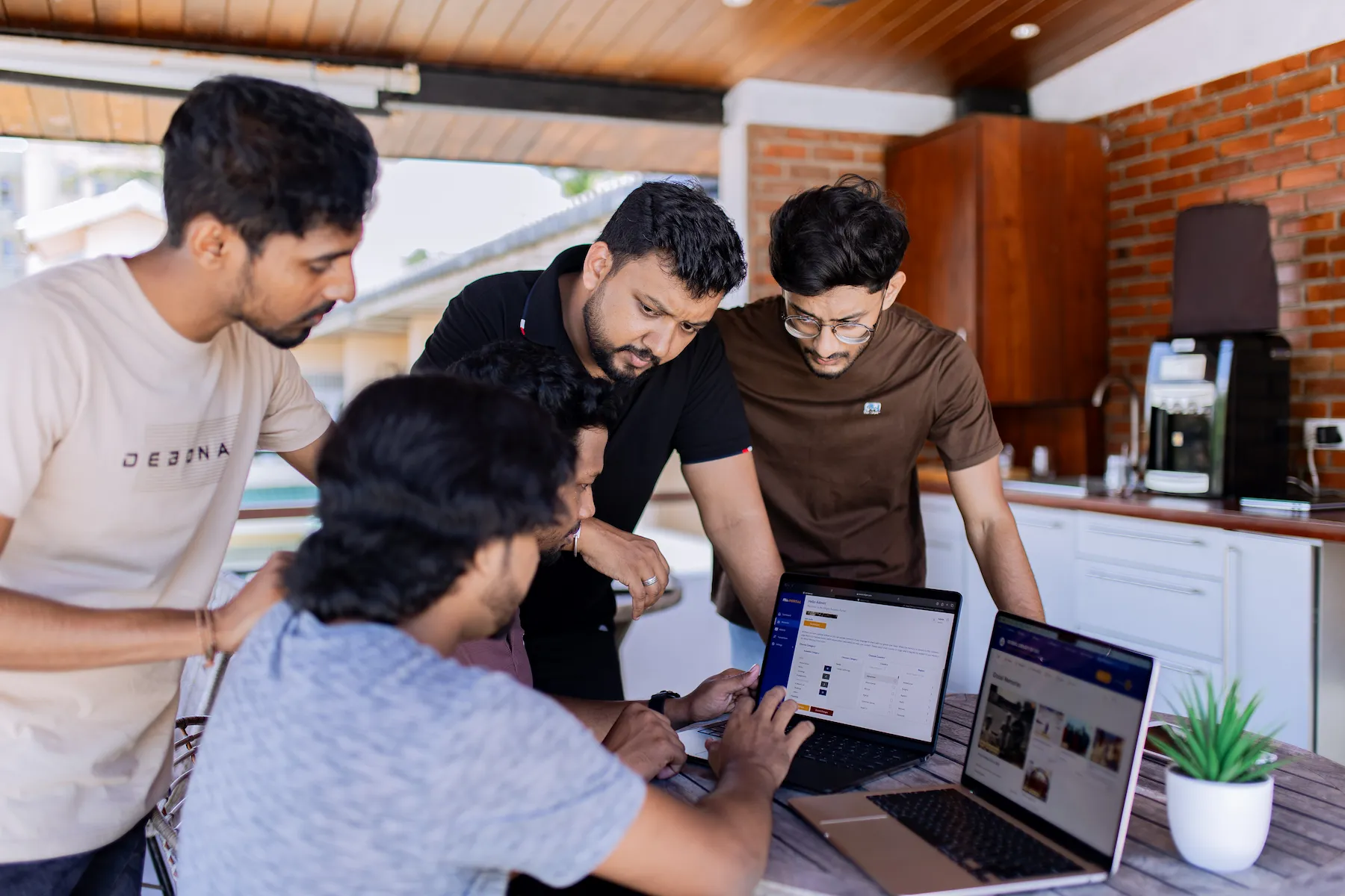 SME web design experts collaborating in office with laptops