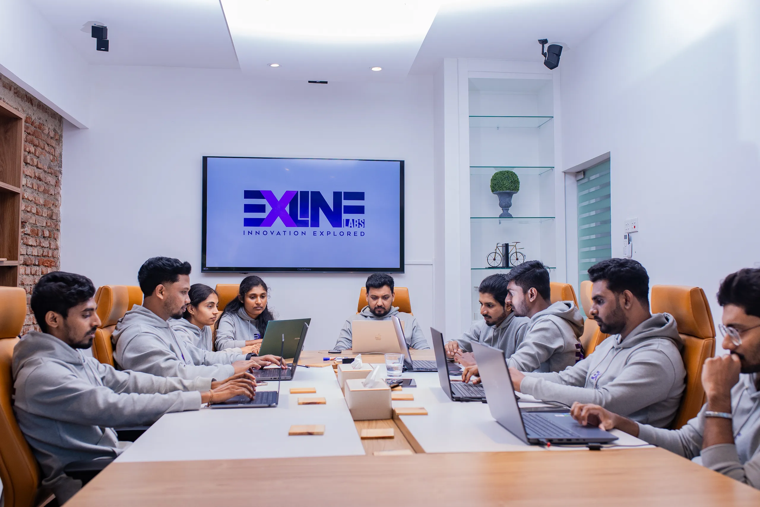 Office discussion with outsourced developers team around table