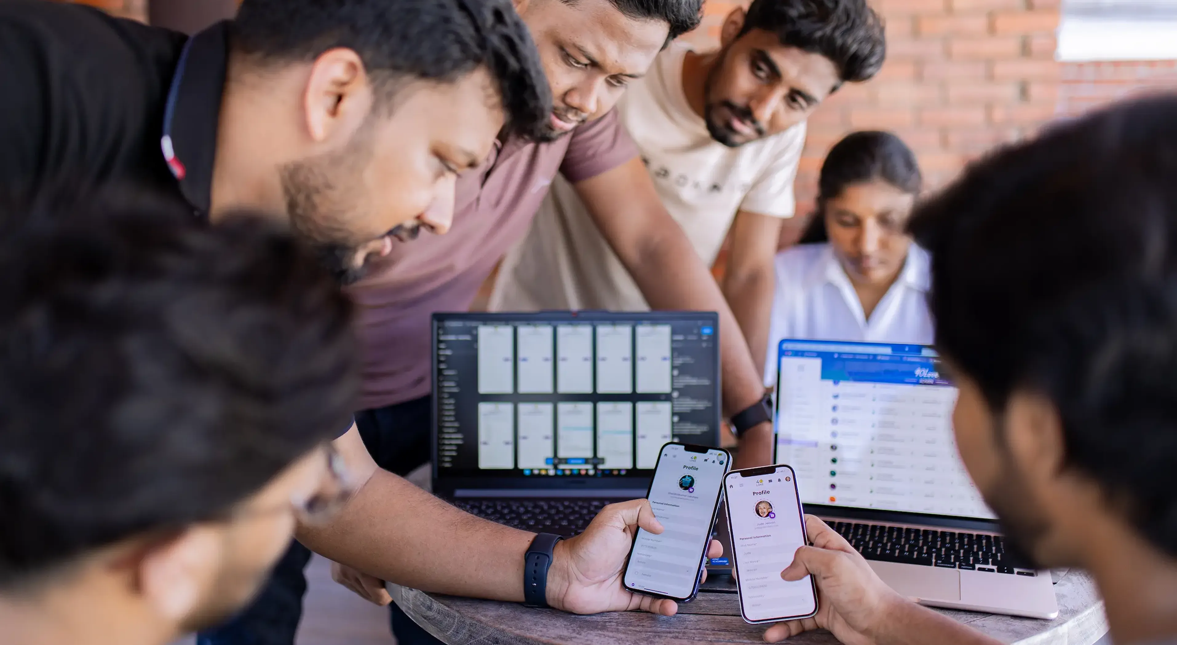 our team, discussing and testing out some of the features of a mobile app built by us.