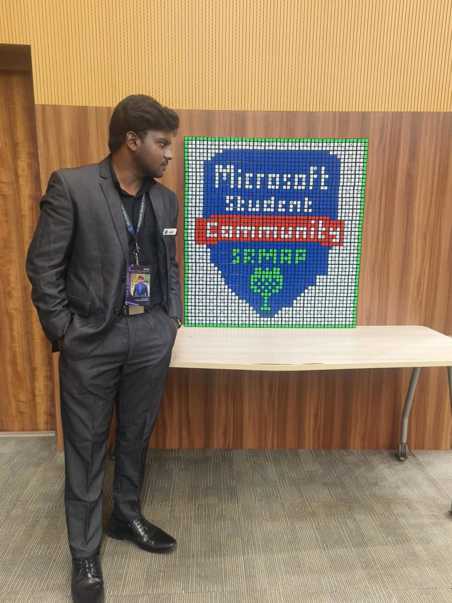 Jayanth Ramakrishnan beside the Microsoft Student Community SRMAP logo built from Rubik’s cubes