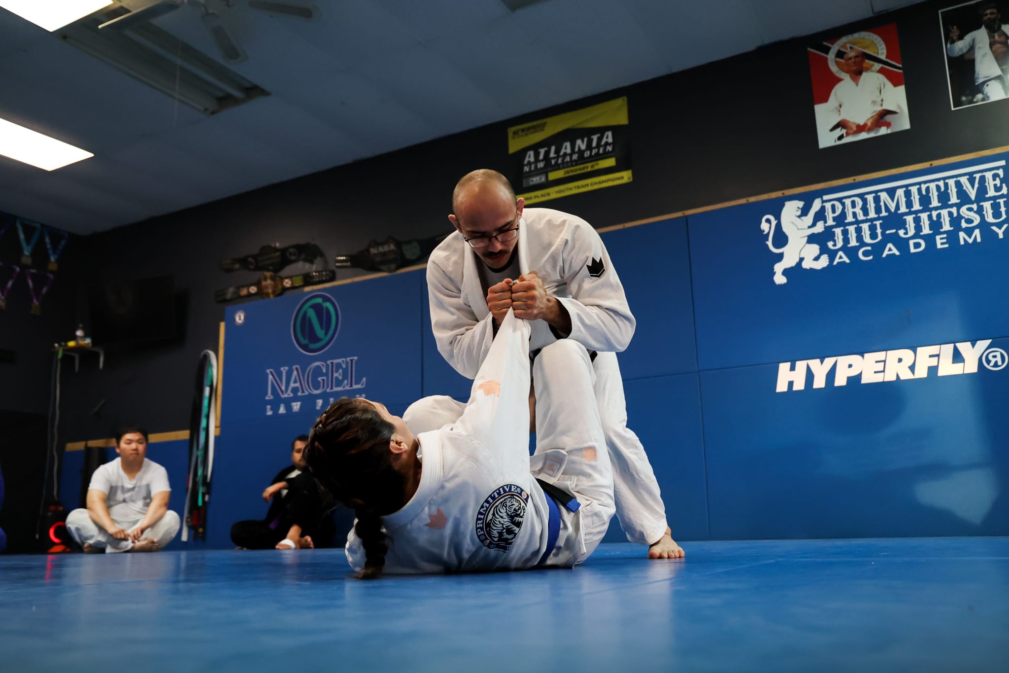 adult jiu jitsu in Lawrenceville, GA wrestling receiving instruction from Elijah Pizarro
