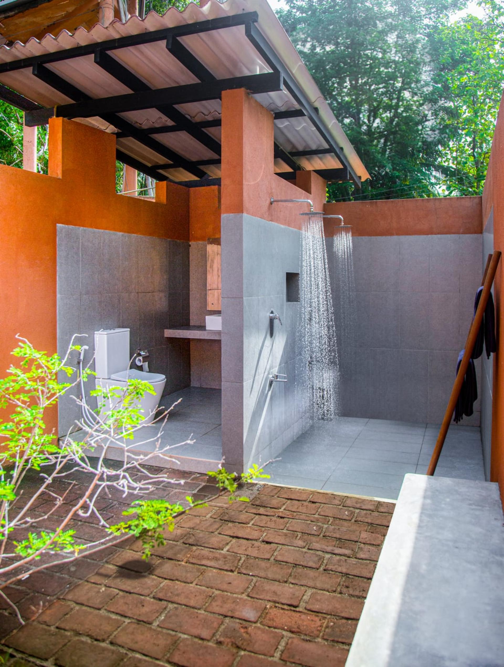 Luxury safari glamping tent with private veranda overlooking natural lake in Udawalawe