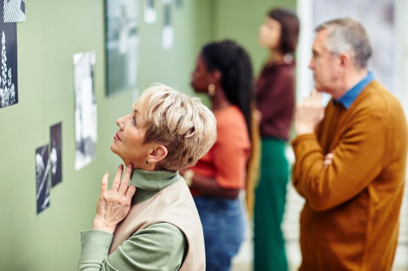 Gallery visitors taking in artwork at an exhibition