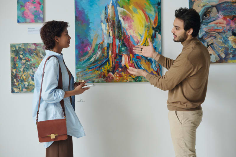 Two guests discussing artwork at a gallery opening