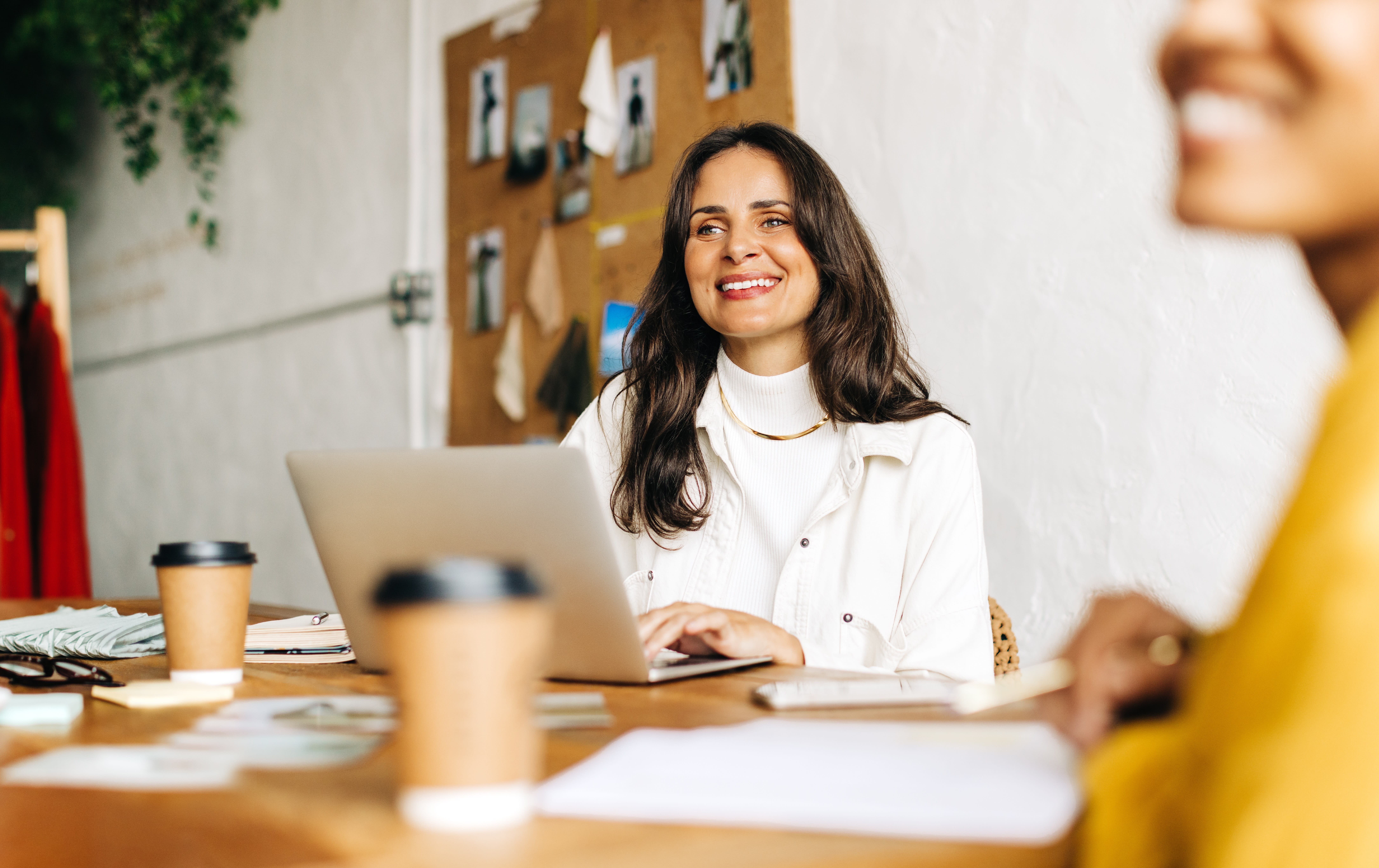 A business woman smiling in a meeting, decisive and engaged