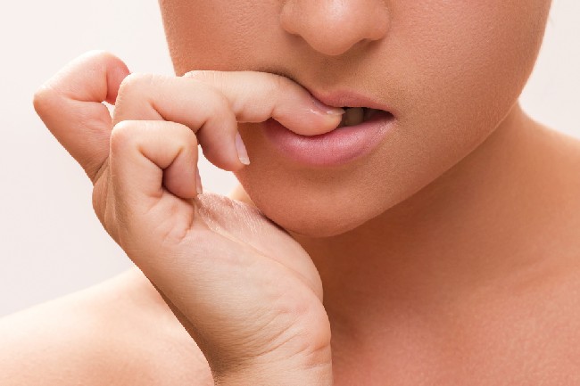 Close,Up,Of,A,Female,Mouth,Biting,Her,Fingers