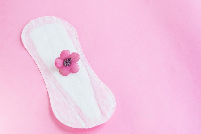 Delicate,Pink,Flower,Placed,On,A,White,Panty,Liner,,Metaphor