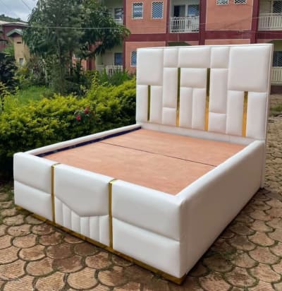 White Upholstered Bed Frame with Gold Accents
