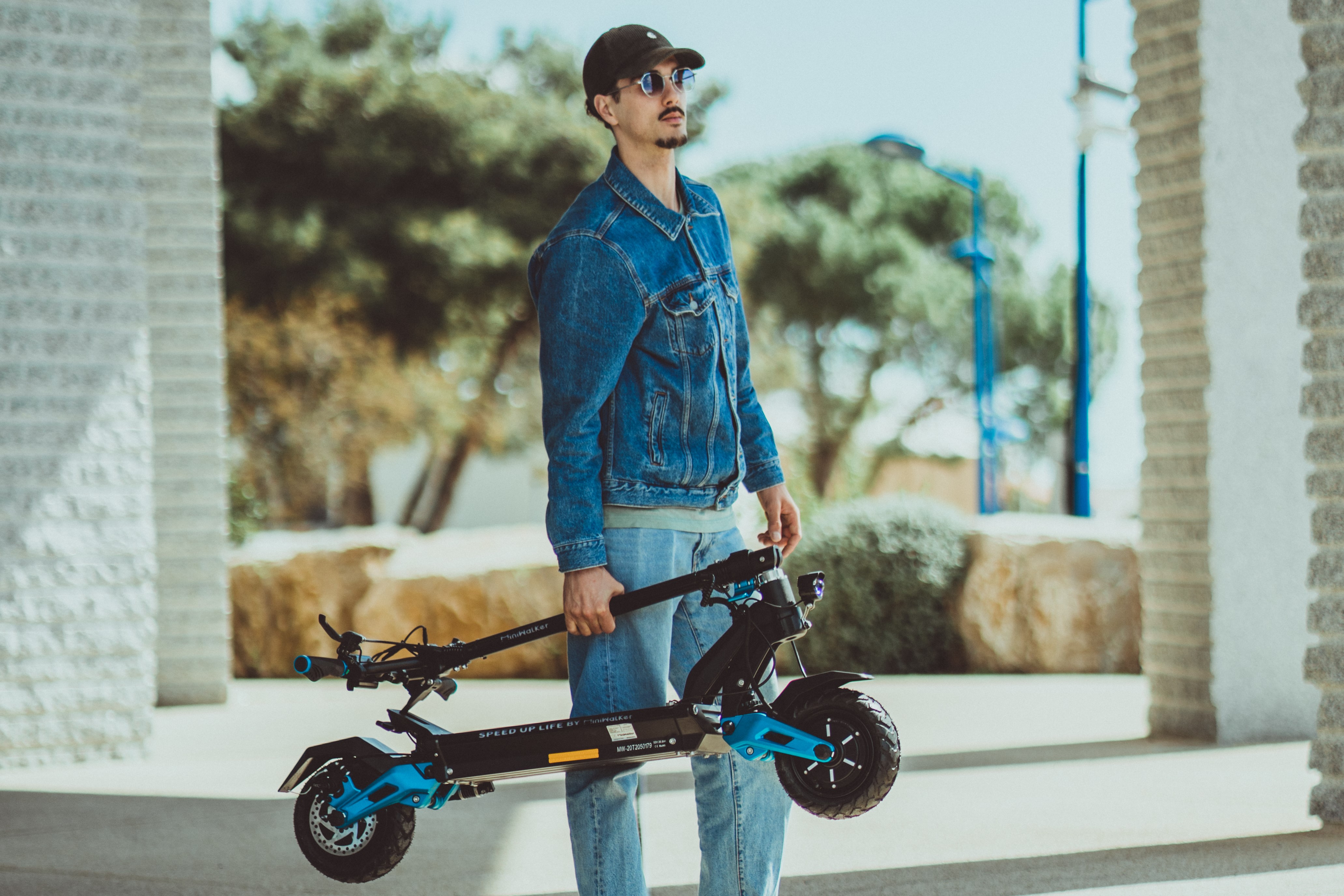 man carry miniwalker electric scooter