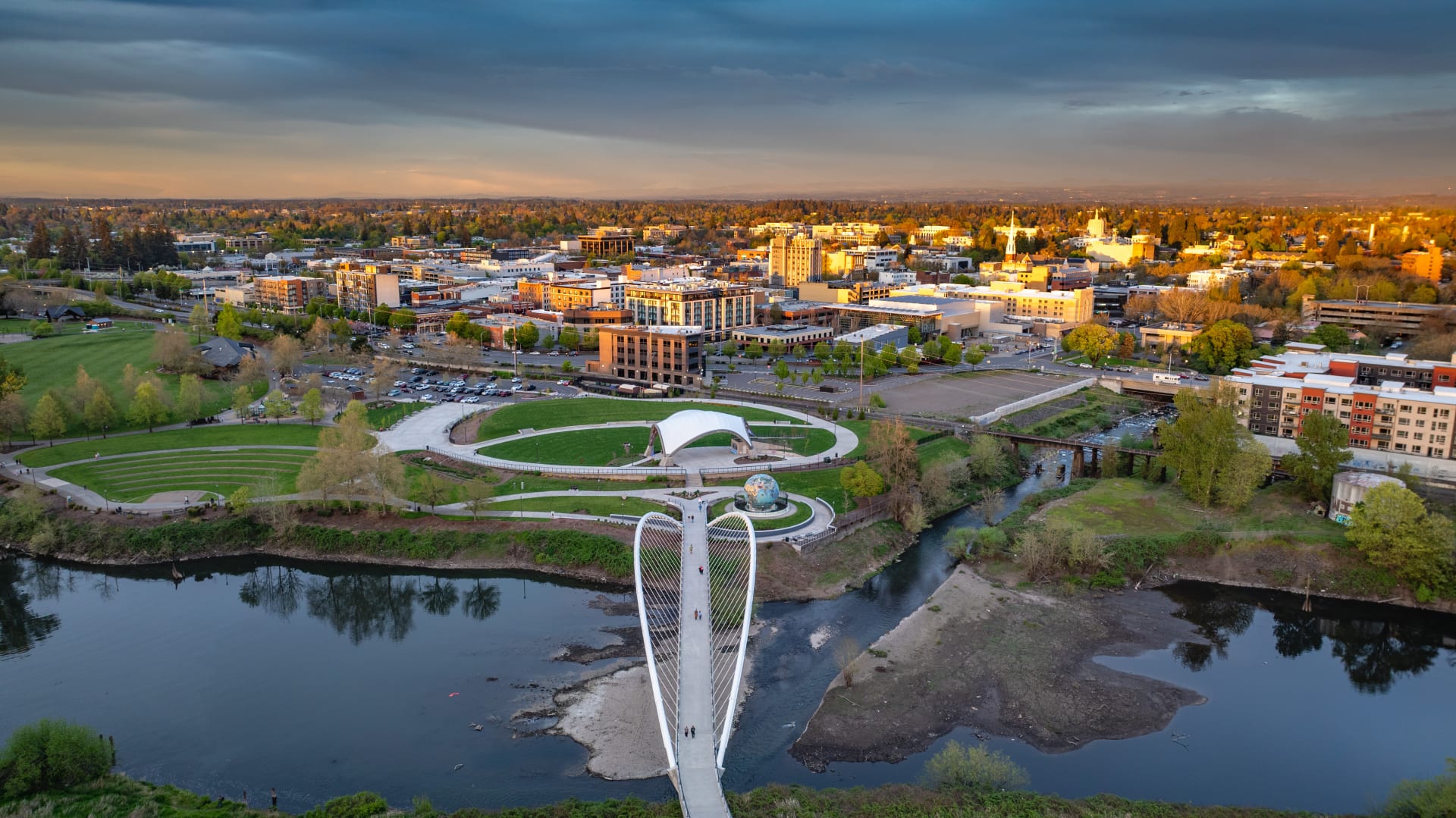 Aerial view of Salem, Oregon at sunset, with the Peter Courtney Minto Island Bridge over the Willamette River, Riverfront Park, downtown Salem and the Oregon State Capitol beyond