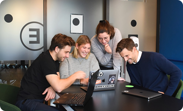 People collaborating around a laptop