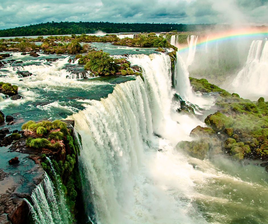 Iguazu Falls cascading through lush rainforest on the Argentina-Brazil border, one of the world's most spectacular waterfalls and UNESCO World Heritage site for group excursions