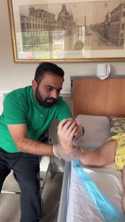 Physiotherapist providing a home-visit treatment session for a patient in Birmingham