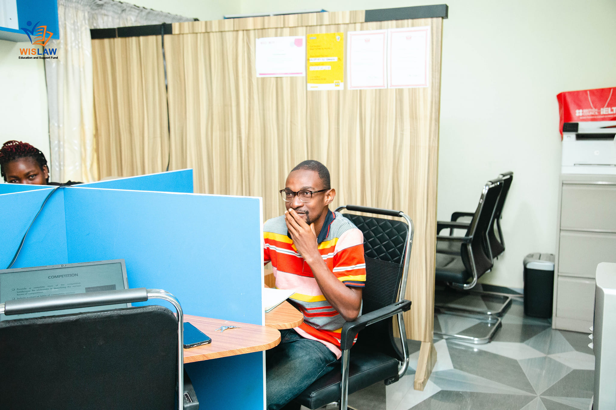 wislaw manager sitting beside a student