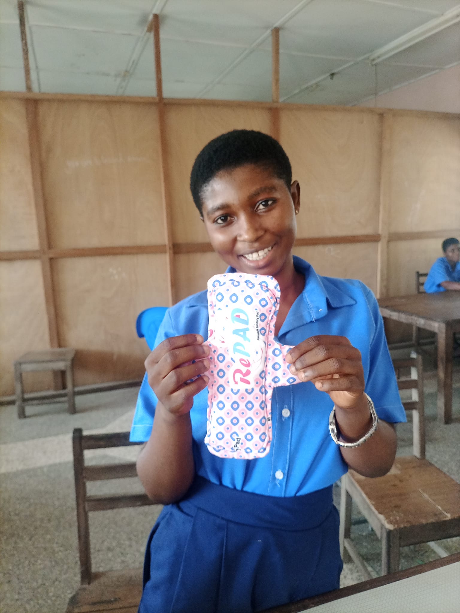 Female student holding a custom cloth made sanitory pad