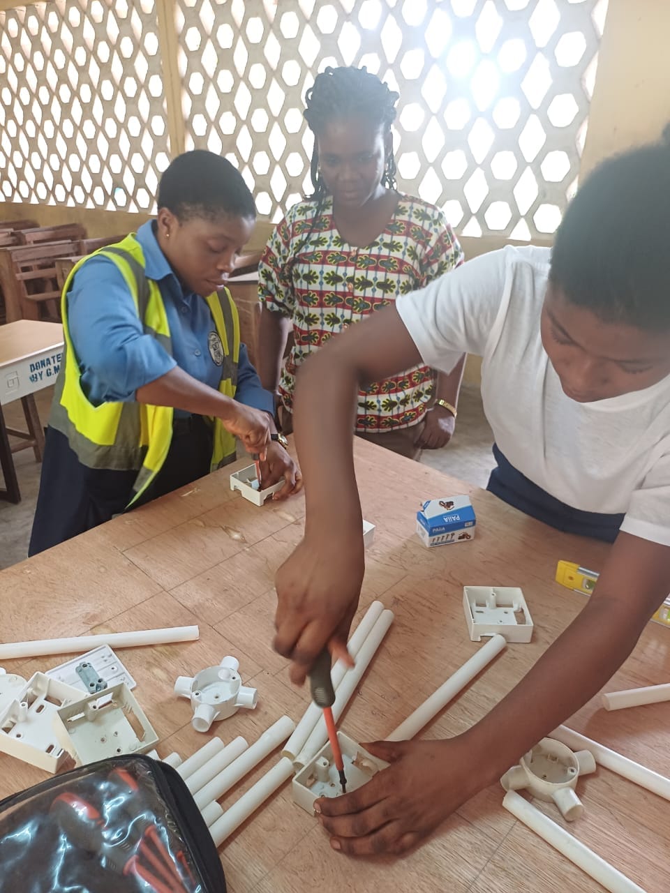 female student fixing an electical socket