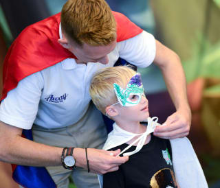 A young boy taking part in our Superhero activity.