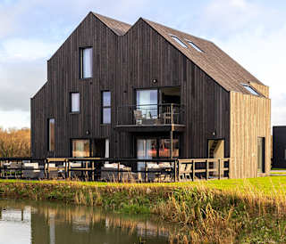 Exterior of our exclusive barn accommodation overlooking our lakes.