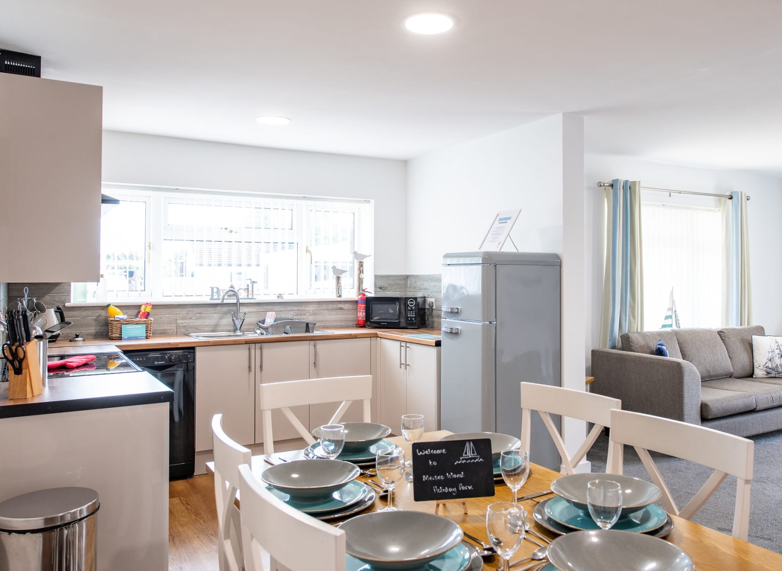 The kitchen and dining area of one of our spacious static caravans at Mersea Island. Book your holiday now! image