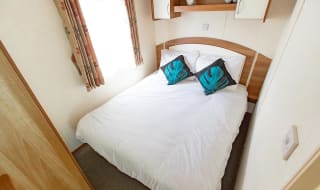 The double bedroom of our budget-friendly value static caravan. The perfect way to stay. image