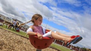 A child playing in the outdoor play area at our holiday park in North Wales, Golden Sands.