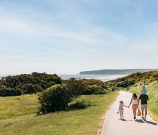 A young family walking to the beach, a stones throw away from our stunning Yorkshire resort, The Bay Filey.
