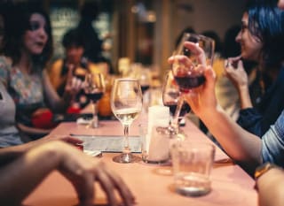 A group of people socialising and enjoying a drink together. image