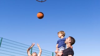 A family enjoying the outdoor sports court at our stunning park in North Wales, Barmouth Bay.