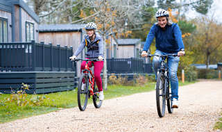 An image of two people cycling through on of our parks together.