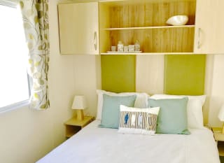The double bedroom in our bright and spacious superior static caravan. The perfect way to stay. image