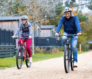 An image of two people cycling through on of our parks together.