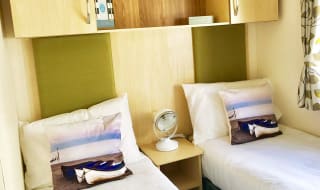 The twin bedroom in our bright and spacious superior static caravan. The perfect way to stay. image