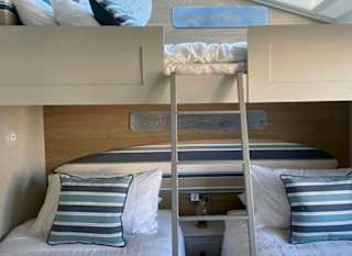 Twin bedroom with bunks at of one of our spacious static caravans in St Ives. Book your holiday now! image