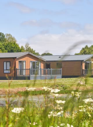 Over lake view of our lodges available to holiday at, Appletree Holiday Park.